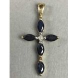 A NINE CARAT GOLD AND SAPPHIRE CRUCIFIX PENDANT