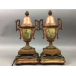 A PAIR OF 19TH CENTURY CERAMIC AND TWIN HANDLED BRASS URNS