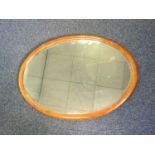 AN EARLY 20TH CENTURY MAHOGANY FRAMED OVAL WALL MIRROR