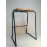 A SET OF THREE INDUSTRIAL/INSTITUITONAL STACKING STOOLS