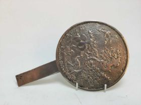 AN EARLY 20TH CENTURY JAPANESE CAST SILVERED METAL HAND MIRROR