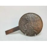 AN EARLY 20TH CENTURY JAPANESE CAST SILVERED METAL HAND MIRROR