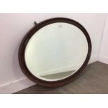 AN EARLY 20TH CENTURY MAHOGANY OVAL WALL MIRROR