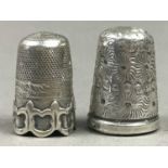 A GROUP OF TWO SILVER AND A WHITE METAL THIMBLE