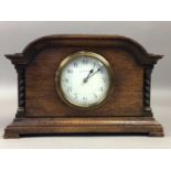 AN EARLY 20TH CENTURY OAK MANTEL CLOCK AND A VICTORIAN CUT GLASS OIL LAMP