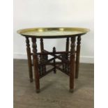 AN EARLY 20TH CENTURY INDIAN BRASS TRAY TOPPED TABLE