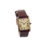 A LADY'S MUST DE CARTIER SILVER GILT MANUAL WIND WRIST WATCH