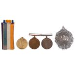 THREE WWI SERVICE MEDALS AND A CAP BADGE