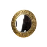 AN ARTS & CRAFTS BRASS CIRCULAR WALL MIRROR