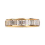 A YELLOW GOLD DIAMOND HALF ETERNITY RING