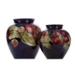 A GRADUATED PAIR OF MOORCROFT 'ANEMONE' PATTERN VASES