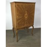 A CONTINENTAL WALNUT COCKTAIL CABINET IN THE MANNER OF EPSTEIN