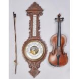 An Edwardian carved oak aneroid barometer, with mercury thermometer, 88cm h and a violin and bow (3)