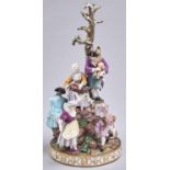 A Meissen group, c1870, of six merrymakers playing music, dancing or eating and drinking on rocks