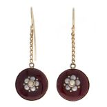 A pair of split pearl and red enamel earrings,  of round design in gold, suspended from a chain,