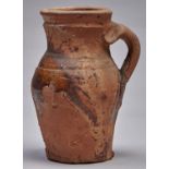An English earthenware jug, probably 19th c, of sandy fabric with splash of ochre glaze, 18cm h
