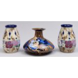 A pair of Continental pottery vases, decorated in art deco style, the marbled bodies with band of