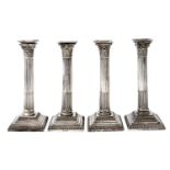 A set of four EPNS columnar candlesticks, c1900, with Corinthian capital, stop fluted shaft and