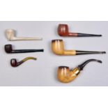 Smoking. Four tobacco pipes, of meerschaum or briar with vulcanite mouthpiece, a 19th c clay pipe,