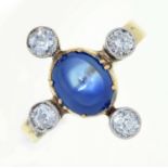 A sapphire and diamond cruciform ring, with larger central cabochon sapphire, in gold, 4.2g, size