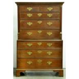 A George III oak chest on chest, with dentil cornice and brass mounted pilasters, later pierced