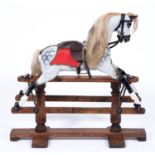 A painted wood rocking horse, on iron mounted wood stand, A W Gamage Ltd, Holborn, London, 90cm h