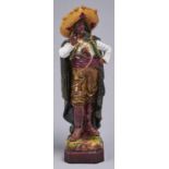 A Continental majolica orientalist figure of a brigand, c1890, 43cm h, impressed H framed by a