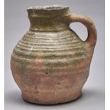 A Medieval Nottingham green glazed earthenware squat jug, 14th c, of hard sandy buff fabric with