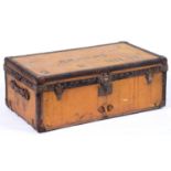 Luggage. A Louis Vuitton trunk, early 20th c, covered in orange Vuittonite canvas trimmed in