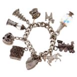 A silver charm bracelet, of flat curb links with padlock and several loose silver charms, to include