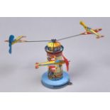 A lithographed tinplate and plastic clockwork spinning aircraft lighthouse toy, c1960 Good