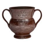 An English saltglazed brown stoneware loving cup, Derbyshire, dated 1831, stamped and incised with a