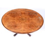 A Victorian walnut and inlaid loo table, with quarter veneered oval top and carved legs, 86 x