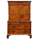 A Queen Anne walnut and feather banded cabinet on chest, c1710, the upper part with stepped