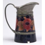 A Moorcroft pewter mounted Pomegranate jug, c1918-29, 14.5cm h Chipped in two places around the edge