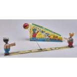 A Japanese lithographed tinplate and fabric clockwork bearing playing ball toy, 1960s, replica