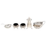 A silver tea strainer, mustard pot and pepperette, Edward VII and George V, various makers and dates