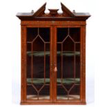 An Edwardian painted satinwood cabinet, with open triangular cornice and dentil frieze, painted with