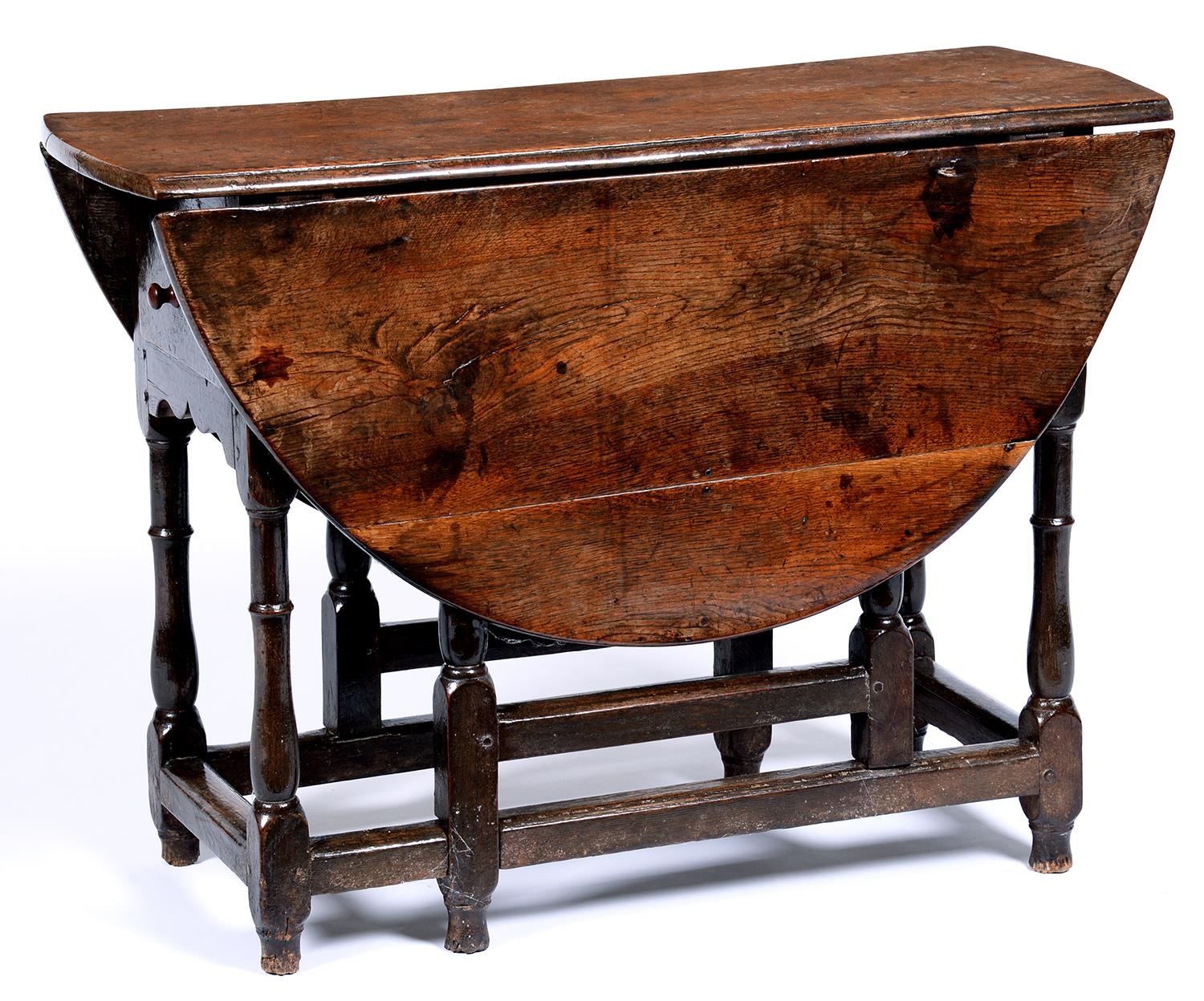 An oak gateleg table, 17th / early 18th c, on baluster legs united by stretchers, 94 x 116cm