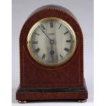 An amboyna mantel timepiece, c1930, with barber ole stringing, the silvered dial inscribed BUTCHER &
