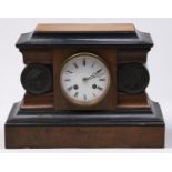 A French walnut and ebonised mantel clock, with bois durci medallions, late 19th c, bell striking