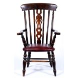 A stained wood elbow chair, with pierced splat Good condition