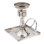 A Continental silver chamberstick, early 19th c, with square pan, 11cm h, later indistinct control