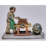 An Arnold lithographed  tinplate  clockwork figural  knife sharpener toy Working order, some rust