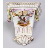 A German floral encrusted porcelain wall bracket, c1900, painted with rustic lovers, loose