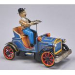 A  Japanese lithographed tinplate and battery and friction powered veteran motor car and driver toy
