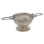 An Elizabeth II silver tea strainer and stand, 12cm over handles, by J A Campbell, London 1996, 2ozs
