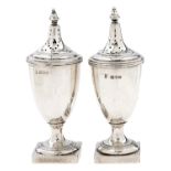 A pair of George V vase shaped silver pepper casters and covers, in neo classical style, 12cm h,