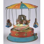 A lithographed tinplate mechanical  carousel  toy, c1960, with four boats Good condition with