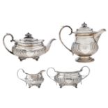 A George III/IV composed silver four-piece tea service, partly fluted with shield cartouche and